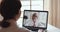 Friendly happy older businesswoman video calling young daughter by webcam