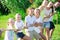 Friendly kids with parents playing tug of war