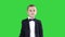 Friendly little boy in a suit says hi and then says bye on a green screen, chroma key.