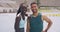 Friendly male and female athletes talking and having fun after training. Portrait of happy athletic man and woman