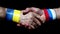 Friendly male handshake. On the wrist is the flag of Ukraine and Russia. World peace no war.