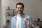 Friendly man broker posing with keys of flat for sale