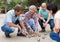 Friendly mature couples playing petanque at leisure