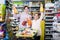 Friendly mother with daughter choosing refreshing beverages in supermarket