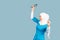 A friendly, muslim doctor or nurse woman in hijab with a stethoscope on a blue background. emotions of victory or success