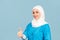 Friendly, muslim doctor or nurse woman in hijab with stethoscope showing thumb up over blue background. emotions of victory or