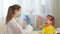 A friendly pediatrician gives a shot to Child. Girl with face mask receiving vaccination, coronavirus, covid-19 and