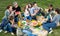 Friendly people sitting and talking on picnic