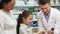 Friendly pharmacist shows little girl one of the tubes