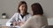 Friendly positive conversation between doctor and older patient