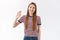 Friendly positive, cute young caucasian girl in striped t-shirt raising palm, waving hand say hi, hello, greeting