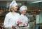 Friendly Positive female staff offering sweets in confectionery