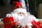 Friendly Santa Claus doll face with curly beard, toy santa