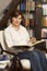 Friendly senior woman sitting and reading a book