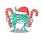 Friendly shigella boydii in Santa Cartoon character holds Christmas candies