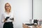 Friendly smiling beautician stand looking at camera at work place