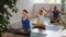 Friendly sporty parents with tween daughter and son stretching to sides while sitting in Lotus pose on mats in yoga