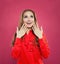 Friendly surprised woman looking up and smiling portrait. Pretty excited model girl on pink background