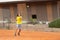 Friendly tennis match - a boy serves the ball