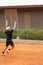 Friendly tennis match - a boy teenager serves the ball