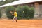 Friendly tennis match - a boy in yellow shirt on the court
