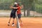 Friendly tennis match - opponents hug above the net
