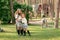 Friendly tween sisters hugging in courtyard of country house with pony in background