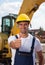 Friendly worker with his bulldozer showing thumb