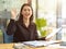 Friendly young business woman smiling and saying hi to her colleagues