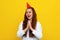 Friendly young cute woman in a celebratory cap feeling happy and successful, smiling and clapping hands, saying congratulations