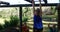 Friends applauding woman while exercising on monkey bar