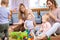 Friends with babies toddlers playing on the floor in sitting room