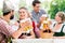 Friends in Bavarian beer garden drinking in summer