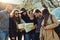 Friends are the best traveling buddies. a group of friends looking at a map while on a road trip.