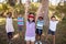 Friends with blindfolded girl cheering in forest