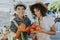 Friends buying fresh tomatoes at a farmers market