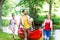 Friends carrying kayak or canoe to forest river