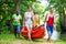 Friends carrying kayak to river in forest