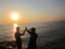 with friends celebrating the success of our trip on the edge of the port of, with a sea as a backdrop with a view of the sunset