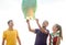 Friends with chinese sky lanterns on the beach