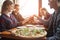 Friends of classmates eat pizza in a pizzeria, students at lunch eat fast food