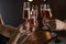 Friends clinking glasses with champagne on blurred background