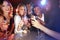 Friends with cocktail drinks, toast in nightclub and smile in party portrait, new year celebration with happy people