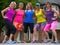 Friends in colorful workout gear playful pose