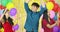 Friends dancing with colorful balloon background at the party in slow motion.