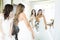 Friends Doing Try-On Of Wedding Gowns In Store