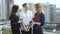 Friends drink coffee standing on the roof. Business woman during lunch break. slow motion