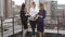 Friends drink coffee standing on the roof. Business woman during lunch break. slow motion