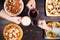 Friends eating pizza. Top view on male hands clinking beer mugs