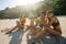 Friends enjoying beach vacation with fresh coconut drink